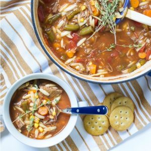 one pot easy vegetable soup in pot with bowl fi