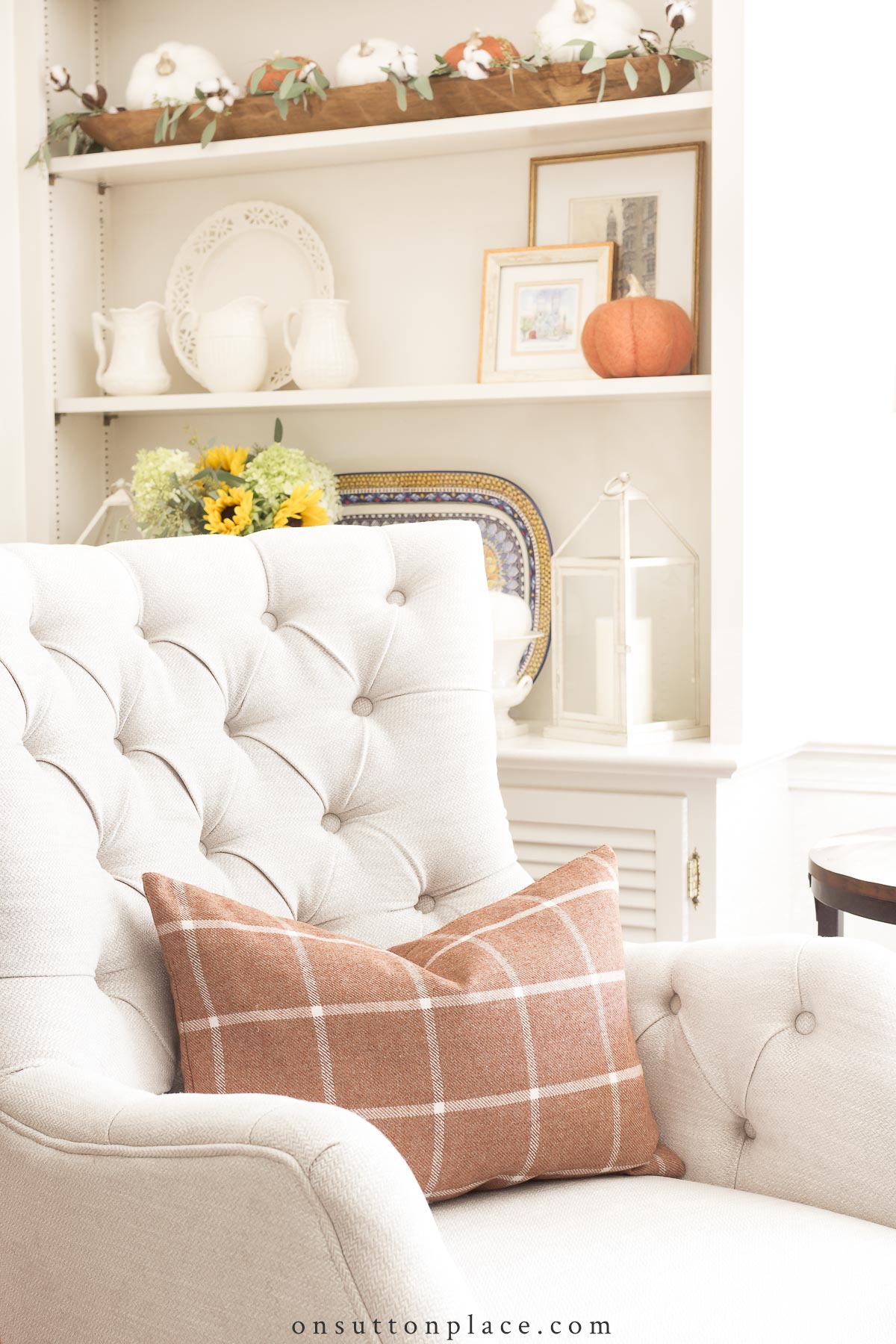 https://www.onsuttonplace.com/wp-content/uploads/2015/09/fall-pillow-on-ivory-tufted-chair.jpg