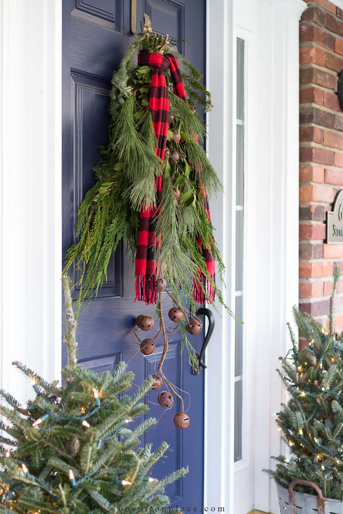 https://www.onsuttonplace.com/wp-content/uploads/2015/12/blue-front-door-with-evergreen-swag-2023.jpg