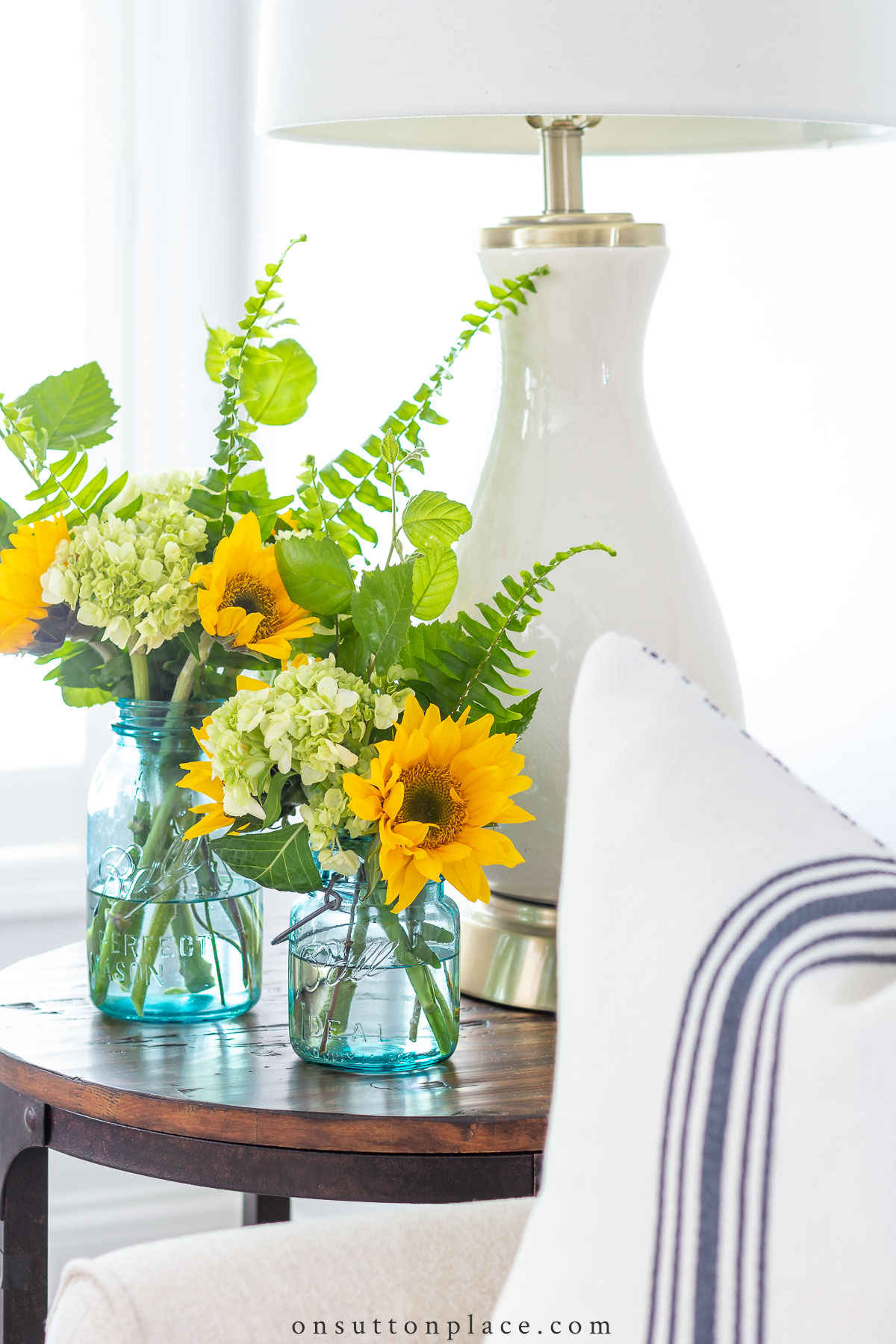 https://www.onsuttonplace.com/wp-content/uploads/2019/02/sunflowers-in-mason-jars-on-end-table.jpg