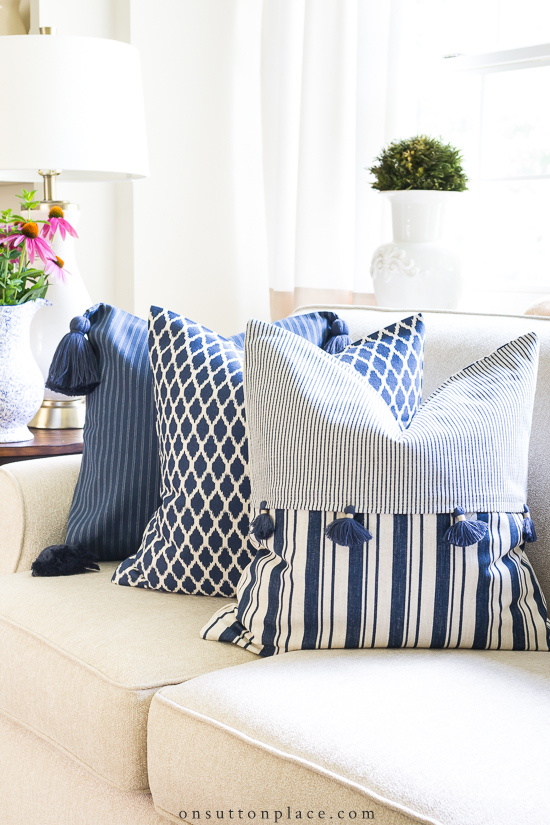 https://www.onsuttonplace.com/wp-content/uploads/2019/07/navy-pillow-covers-on-sofa.jpg