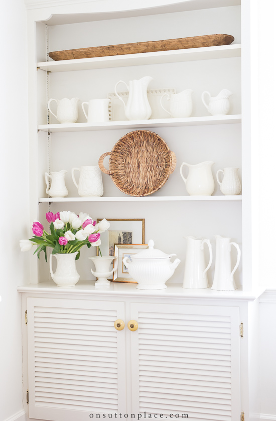 Cabinet With Shelves On Top And White Pitchers 