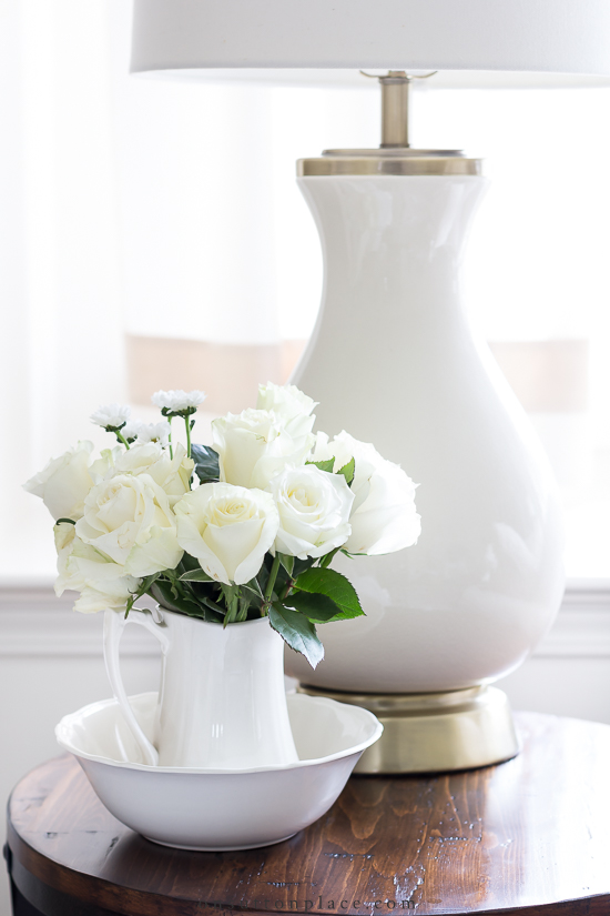 https://www.onsuttonplace.com/wp-content/uploads/2021/01/white-roses-in-pitcher-on-round-table.jpg