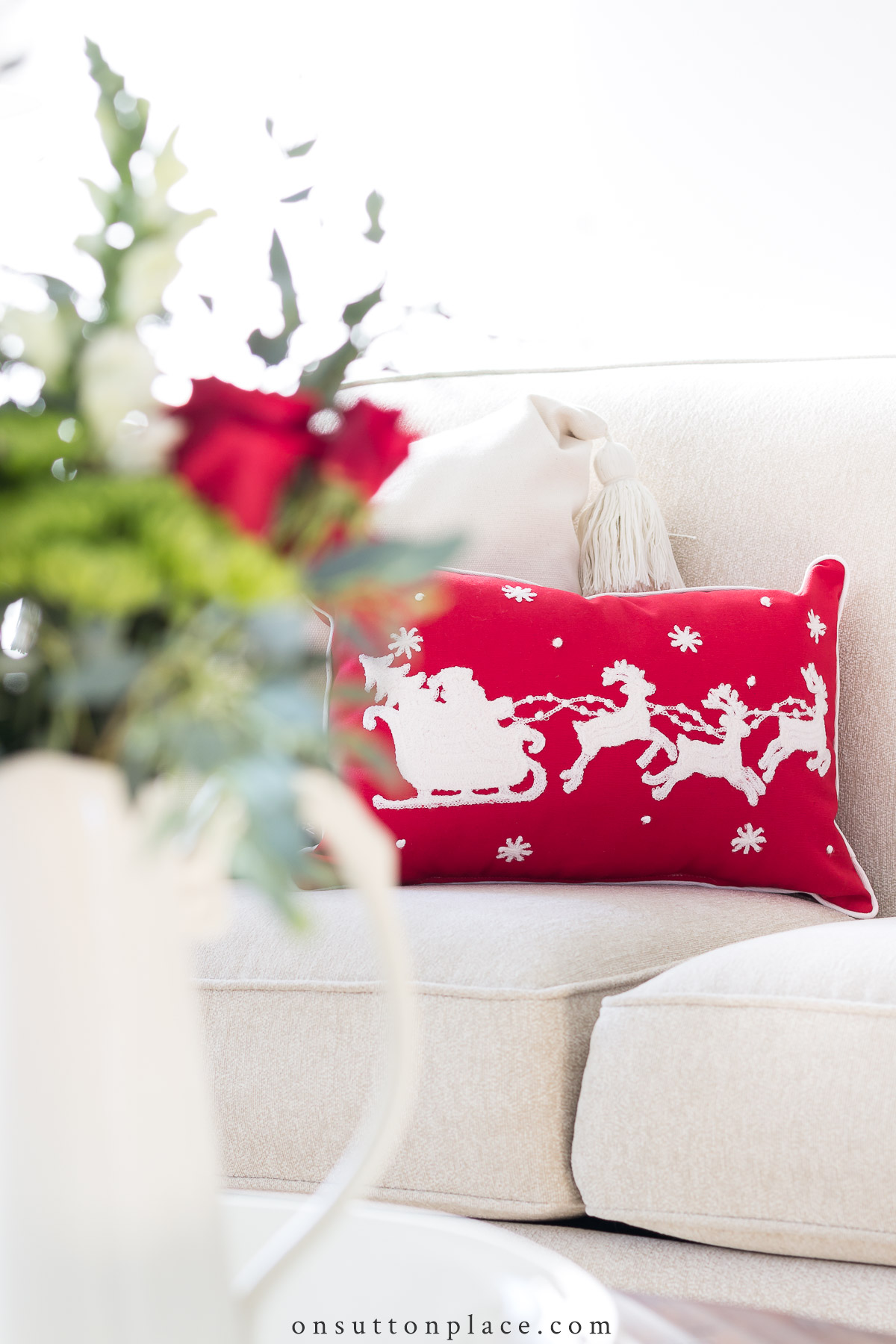 https://www.onsuttonplace.com/wp-content/uploads/2021/12/red-christmas-pillow-with-santas-sleigh.jpg