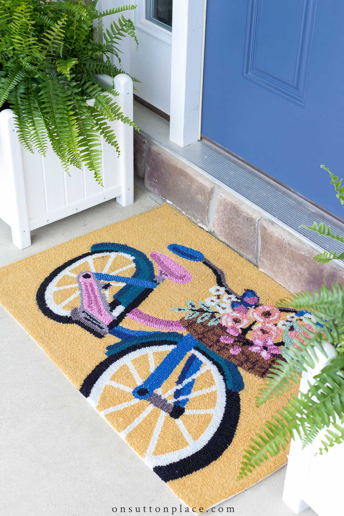 https://www.onsuttonplace.com/wp-content/uploads/2022/05/easy-spring-porch-refresh-cute-bicycle-doormat1.jpg