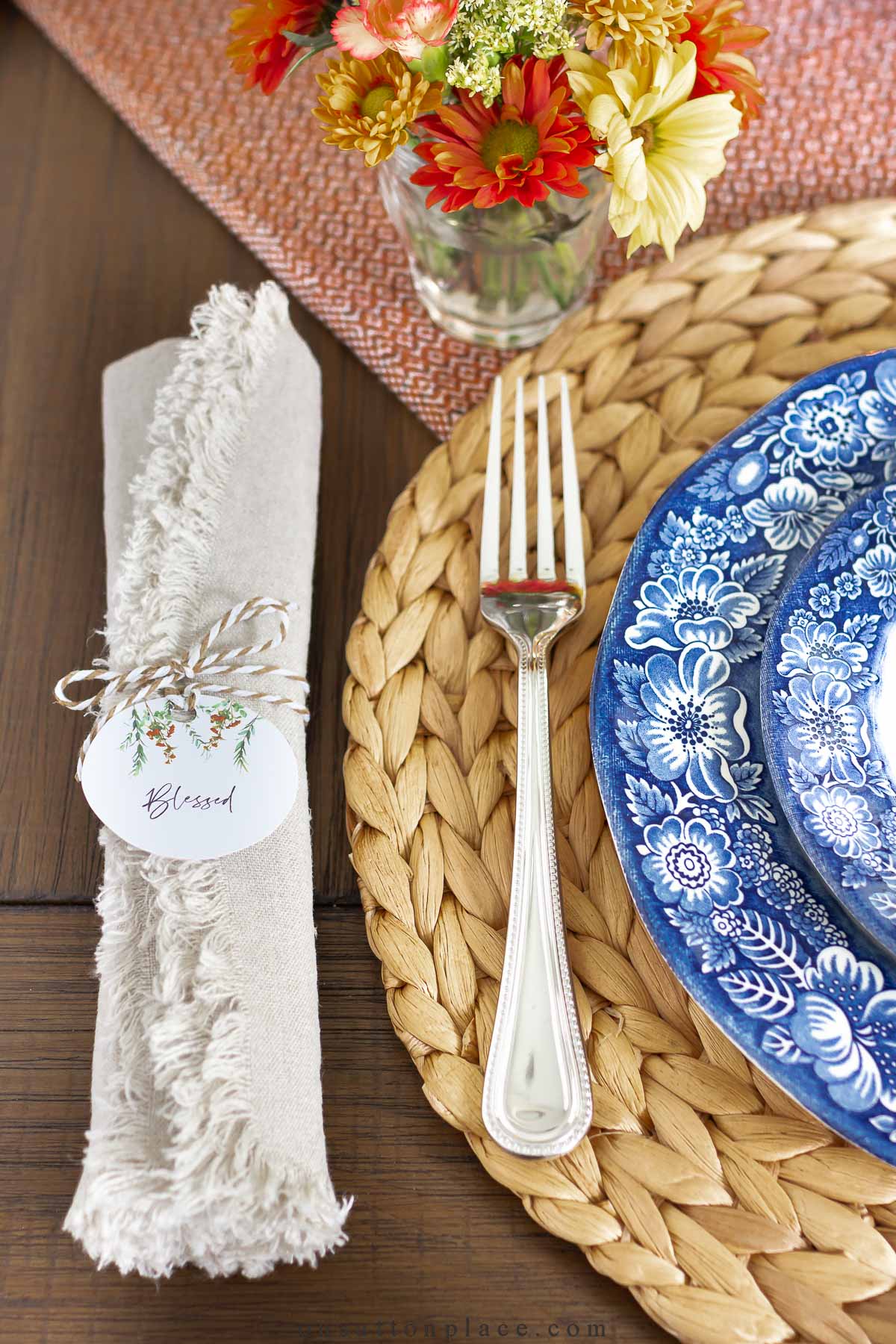 https://www.onsuttonplace.com/wp-content/uploads/2022/10/place-setting-with-cloth-dinner-napkin-and-liberty-blue-plates.jpg