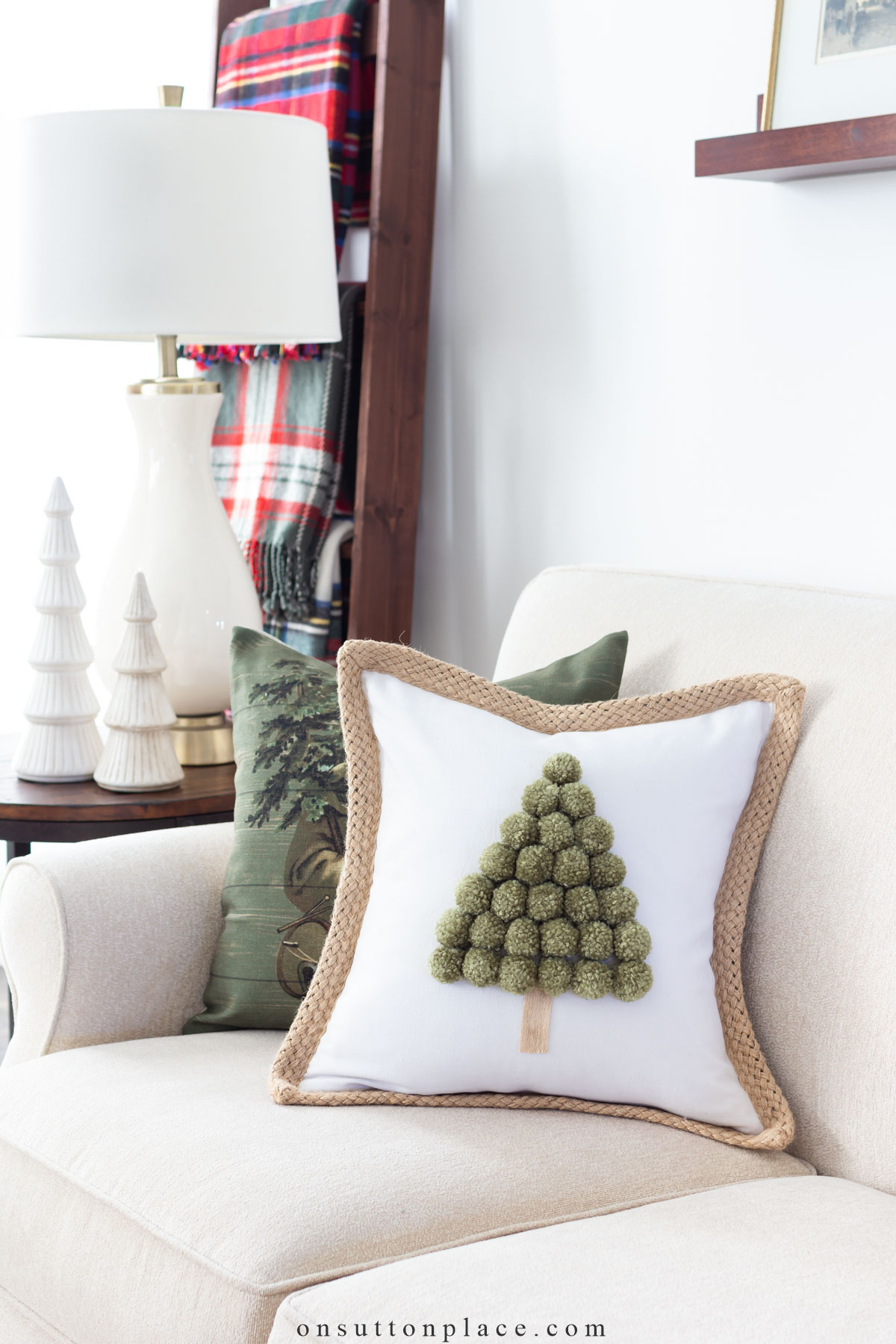 https://www.onsuttonplace.com/wp-content/uploads/2022/12/christmas-tree-pillow-on-sofa.jpg