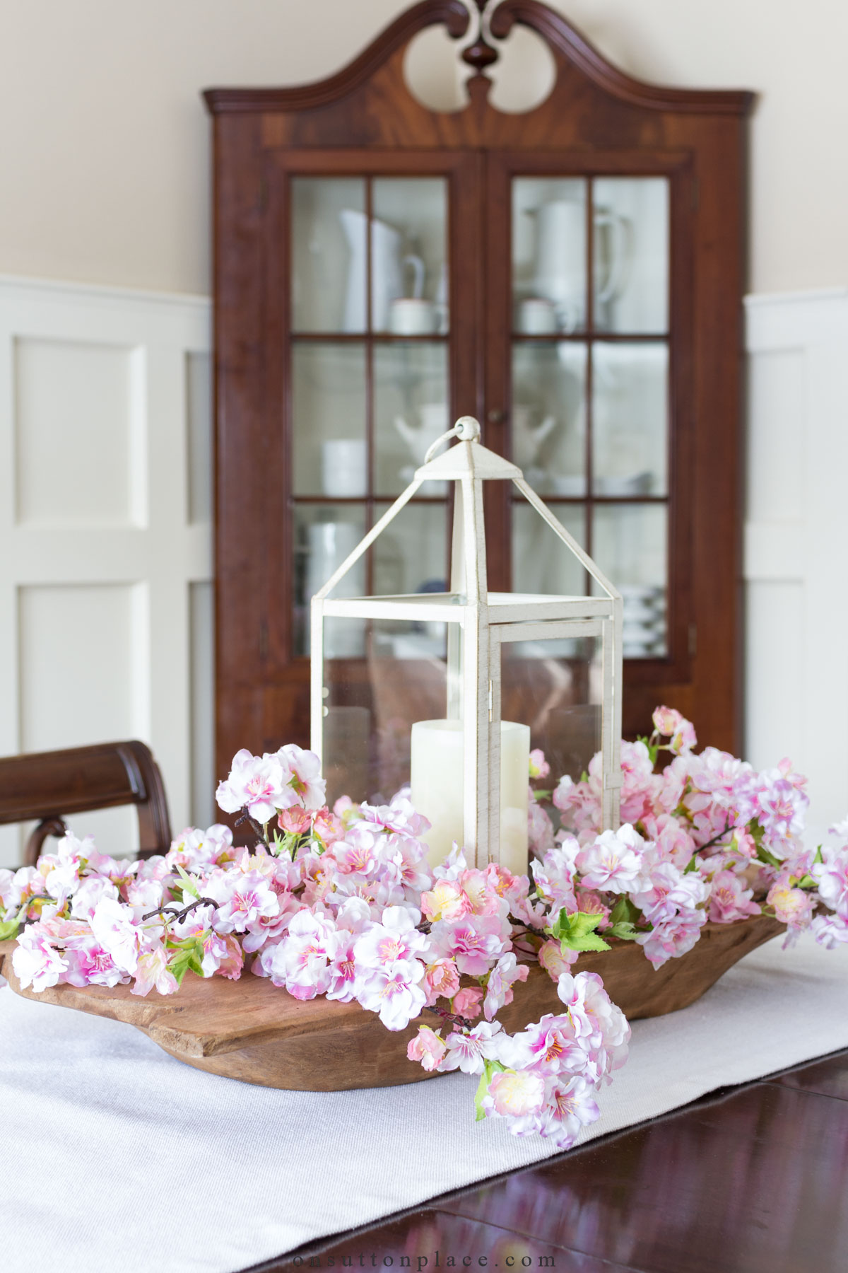 https://www.onsuttonplace.com/wp-content/uploads/2023/07/dining-room-table-centerpiece-with-dough-bowl-cherry-blossoms-.jpg