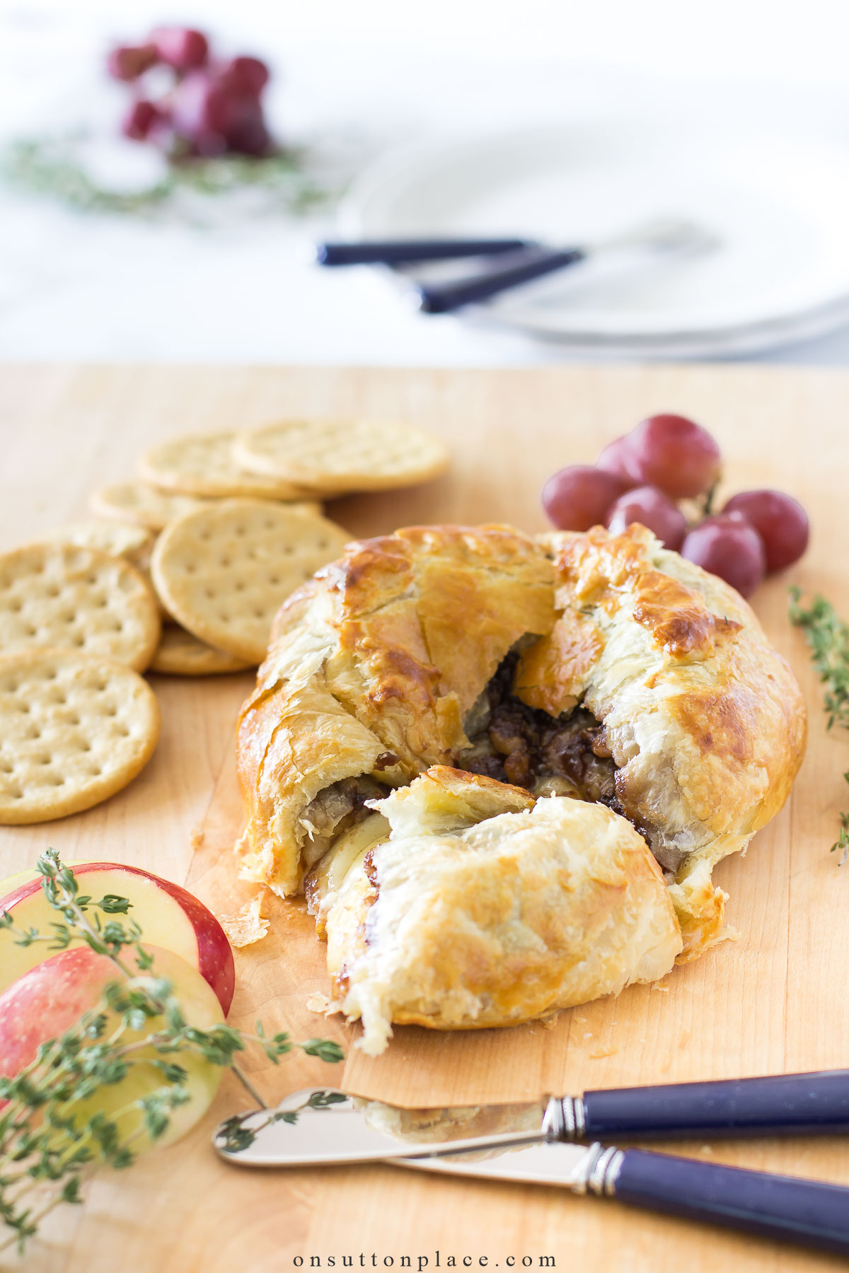 https://www.onsuttonplace.com/wp-content/uploads/2023/08/wood-board-with-fig-walnut-baked-brie-in-puff-pastry.jpg