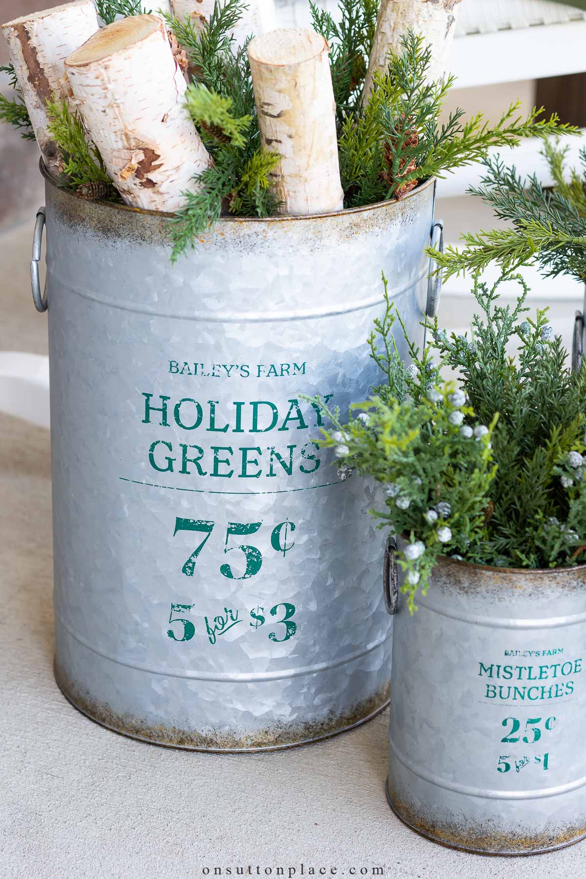 https://www.onsuttonplace.com/wp-content/uploads/2023/11/christmas-porch-decor-holiday-greens-buckets.jpg